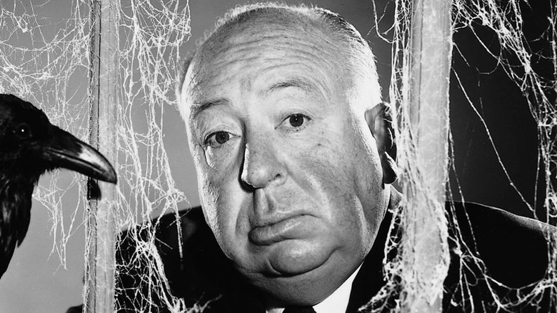 Alfred Hitchcock poses with bird