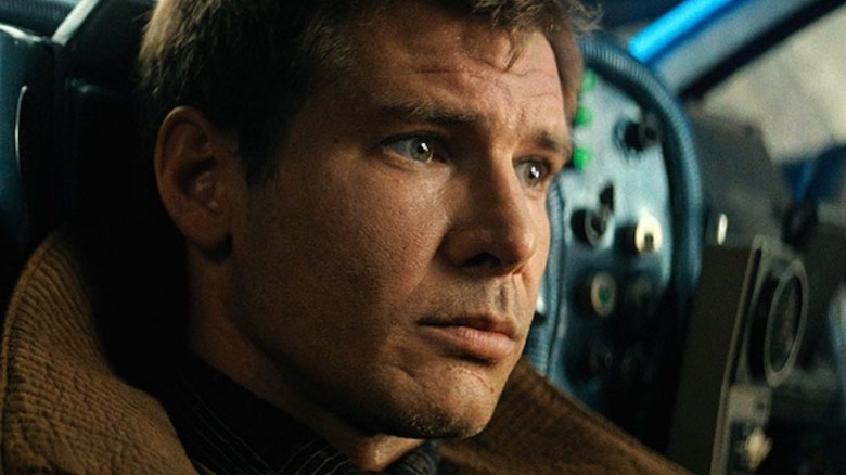 Deckard aims a gun